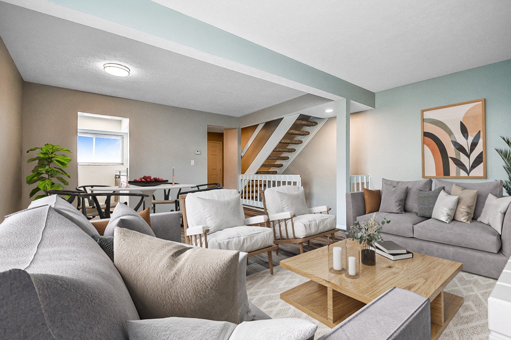 a living room with couches and chairs and a table