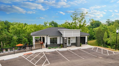 a home with a parking lot and a fence