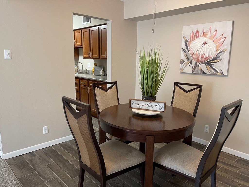 a dining room with a table and chairs