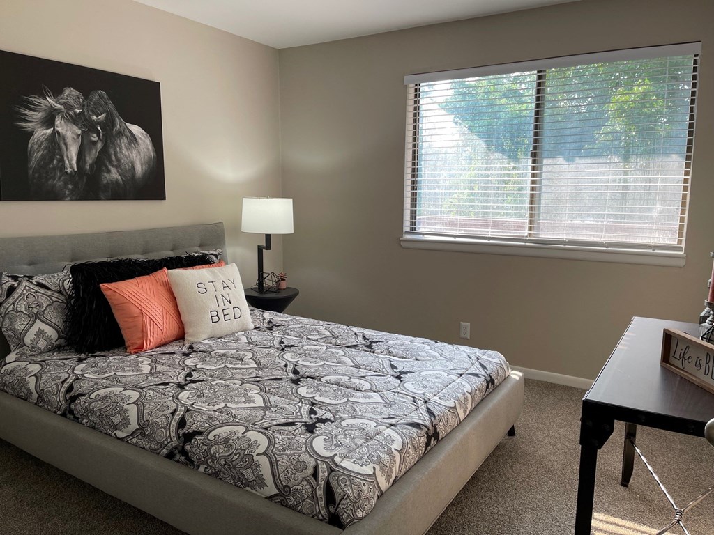 a bedroom with a bed and a window