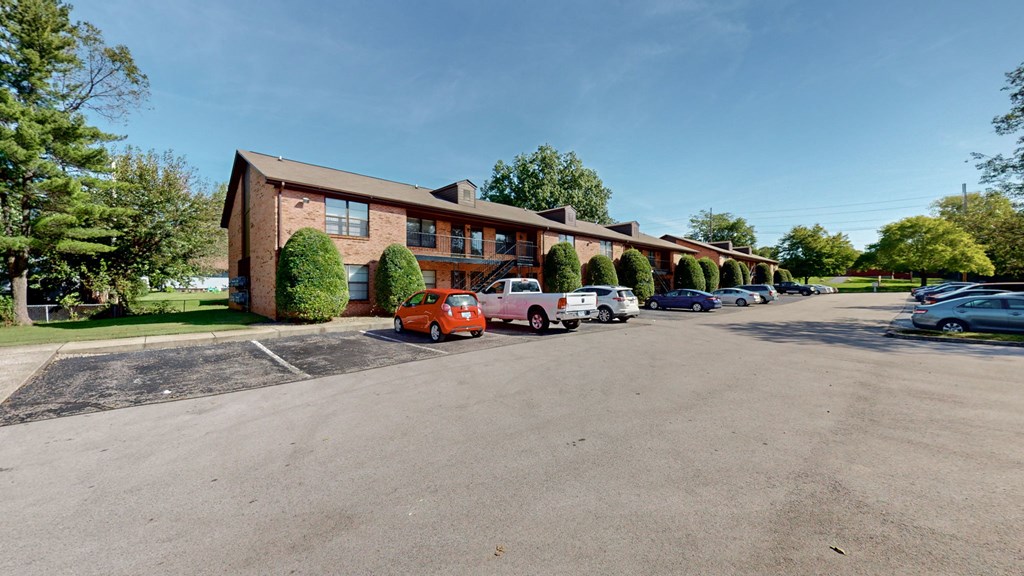 a large brick building with cars parked in front of it