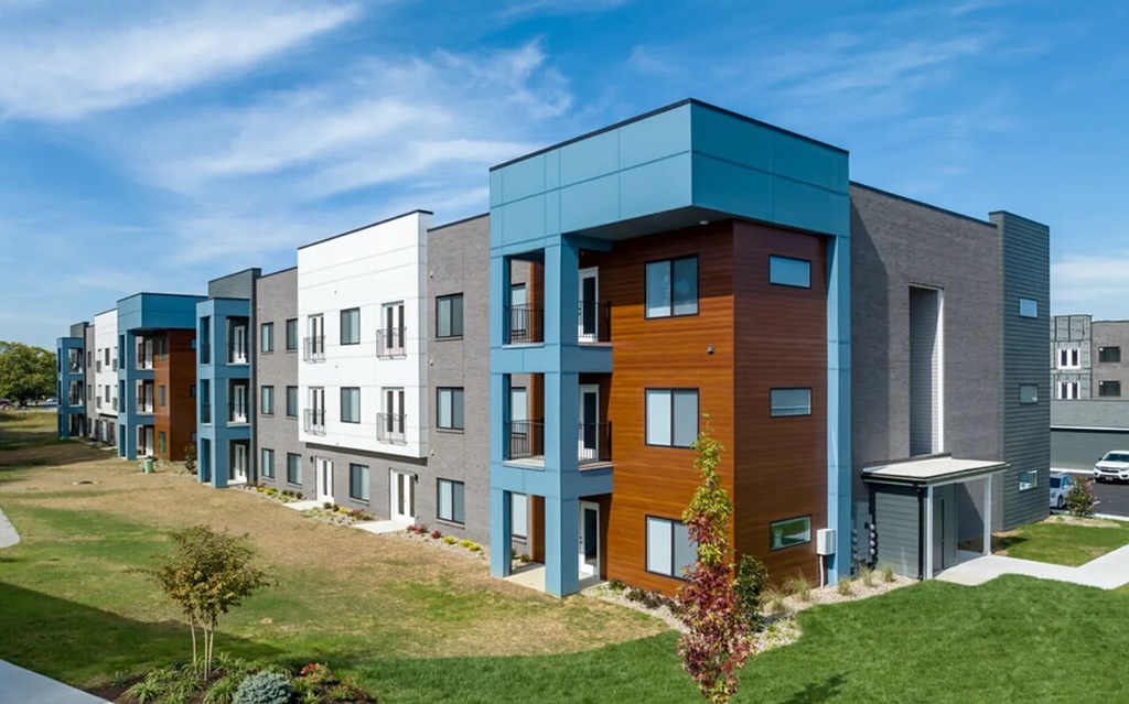 A row of modern townhouses with different colored exteriors.