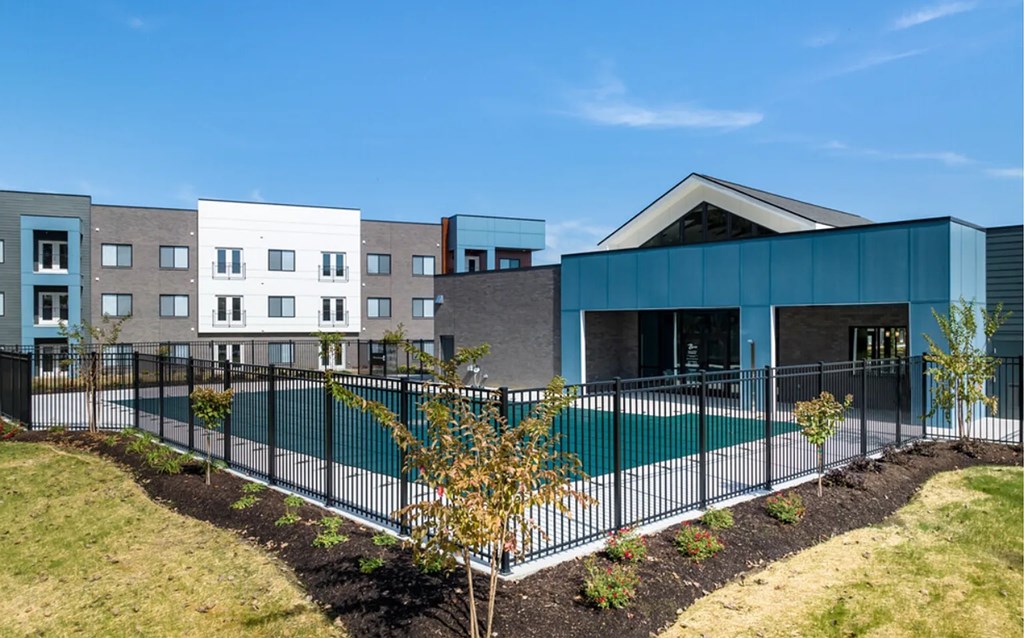 A modern building with a pool in front.