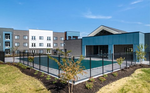 A modern building with a pool in front.