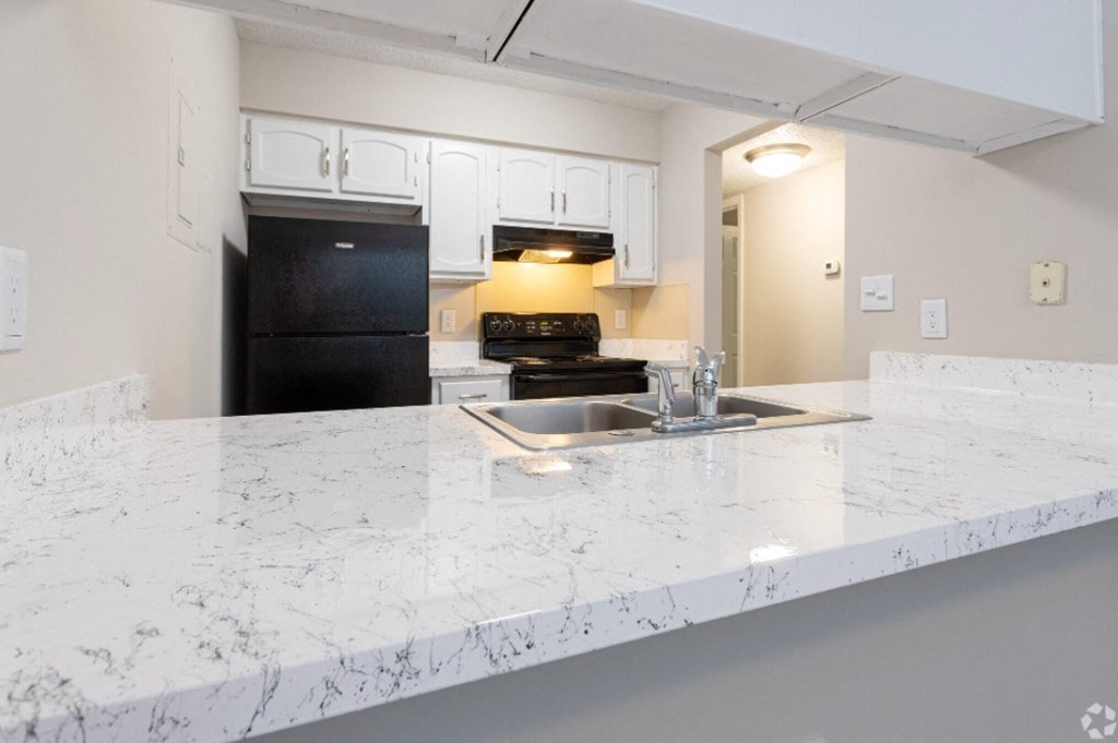 a kitchen with a marble counter top and a sink