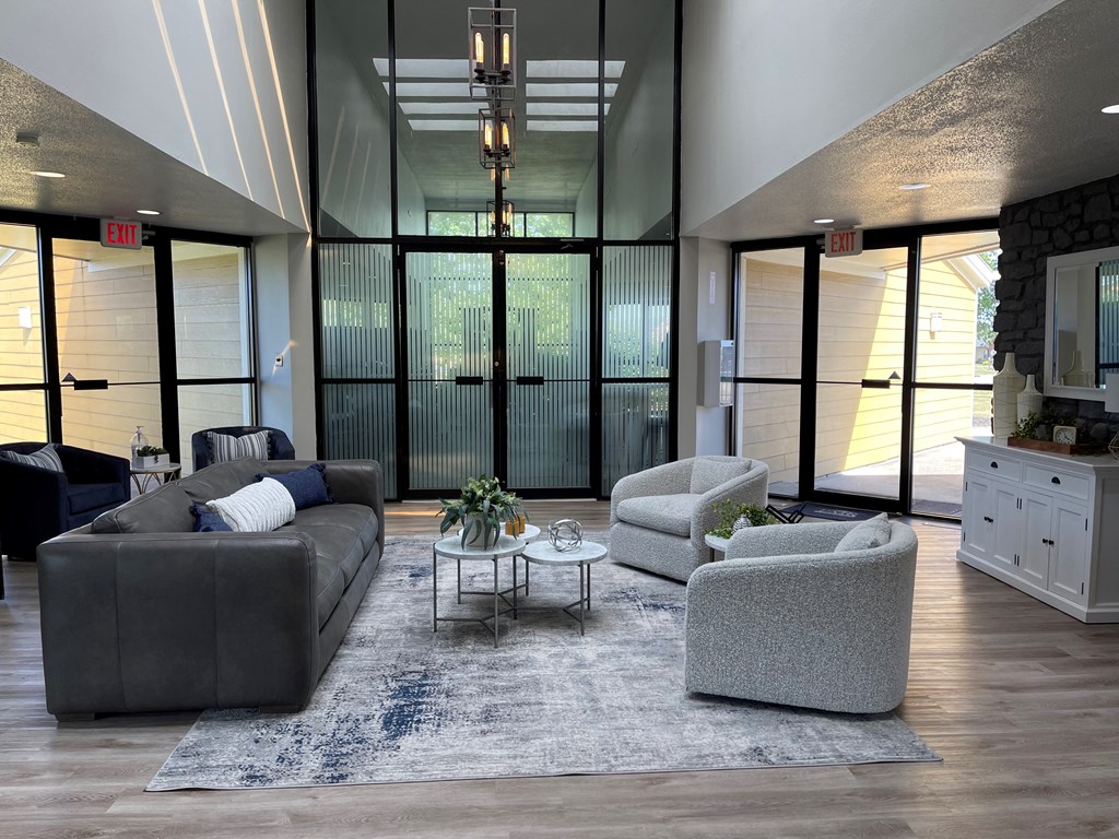 a living room with couches and chairs and a rug