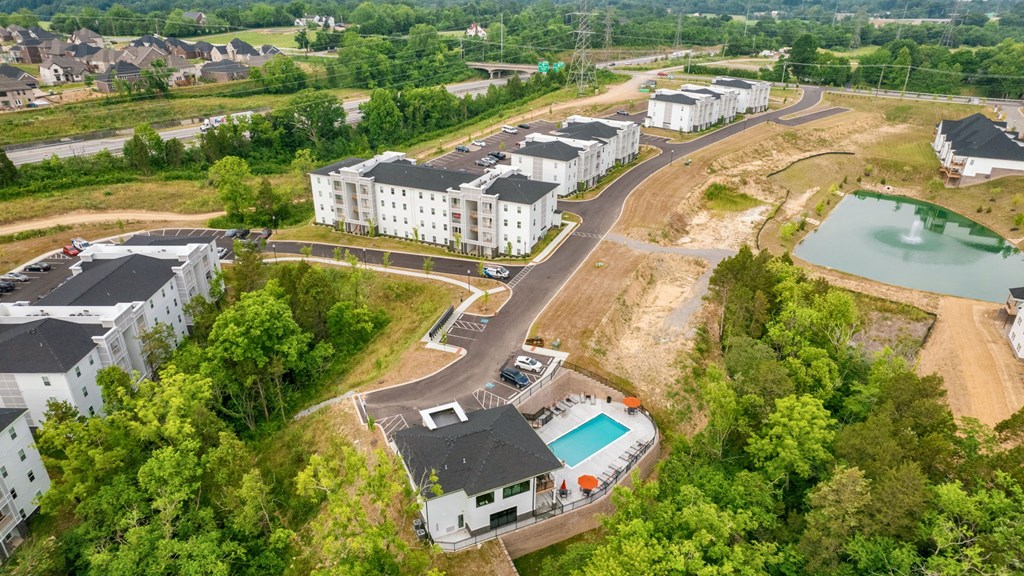 an aerial view of the apartments and a pool in the middle of the city