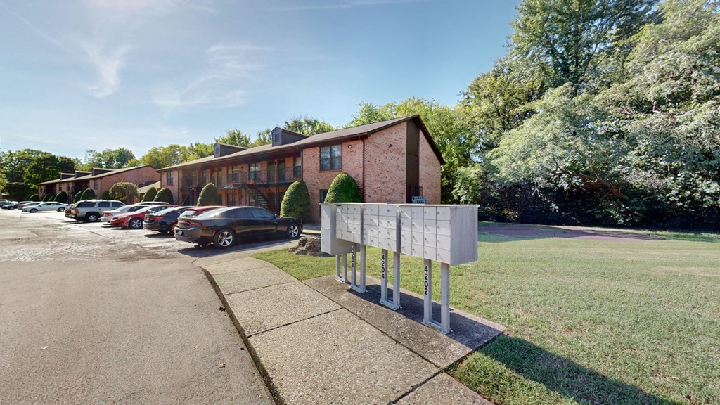 a sign on a sidewalk in front of a brick building