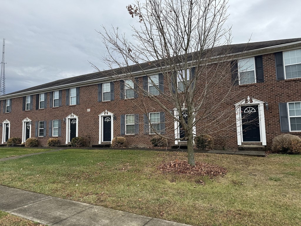 a brick building with a tree in front of it
