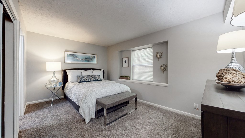 a bedroom with a bed and a window