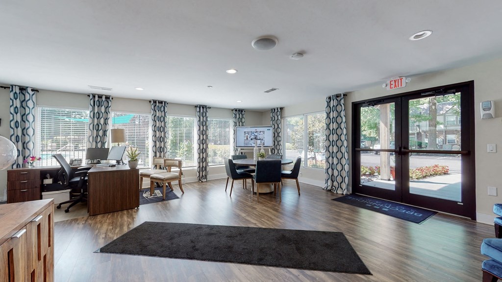 a living room with a table and chairs and a glass door