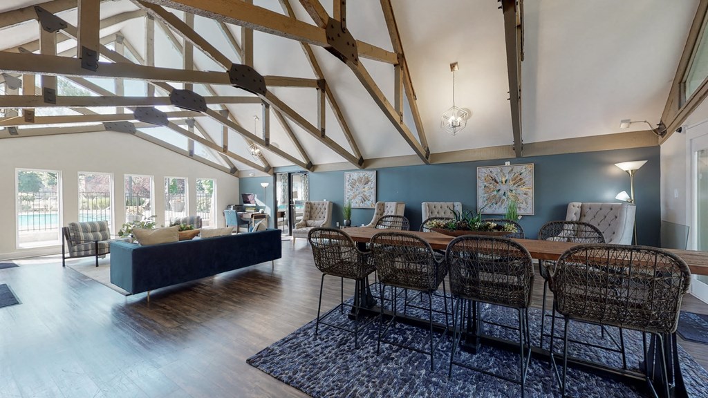 the living room and dining area of a house with exposed wood beams and a large