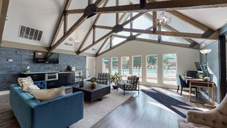 an open living room with a large vaulted ceiling and a view of a pool