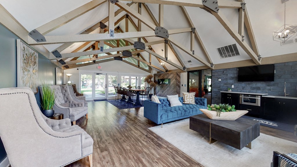 a living room with a blue couch and a fireplace