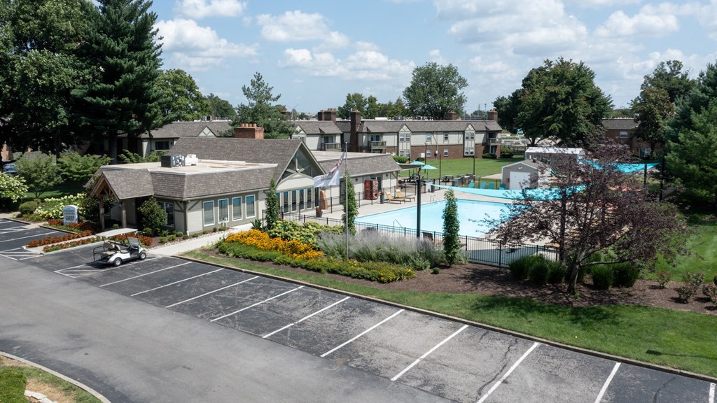 an aerial view of a swimming pool with houses in the background