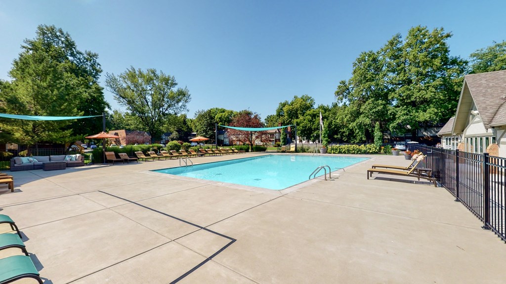 our resort style swimming pool is next to our club house with trees