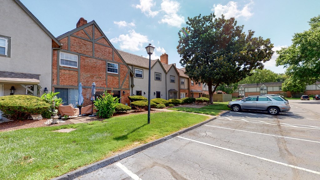 a car parked in a parking lot in front of an apartment building
