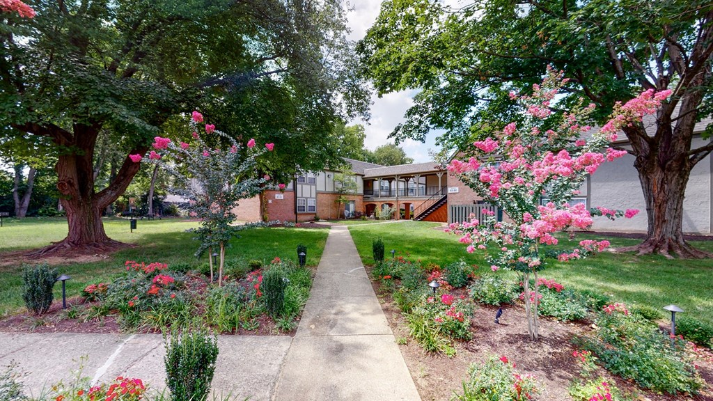 the front yard of a home with a garden and sidewalk