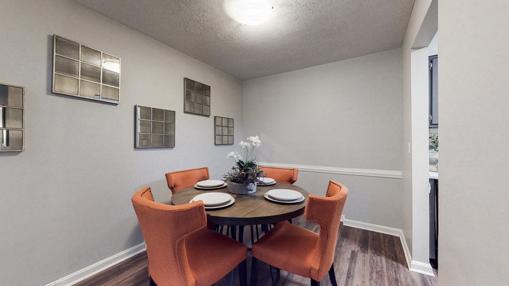 a dining room with a table and chairs and a window