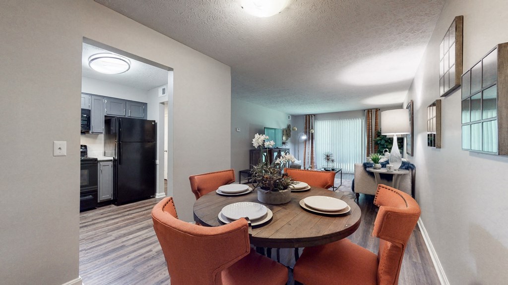 our apartments have a dining room and living room with a table and chairs