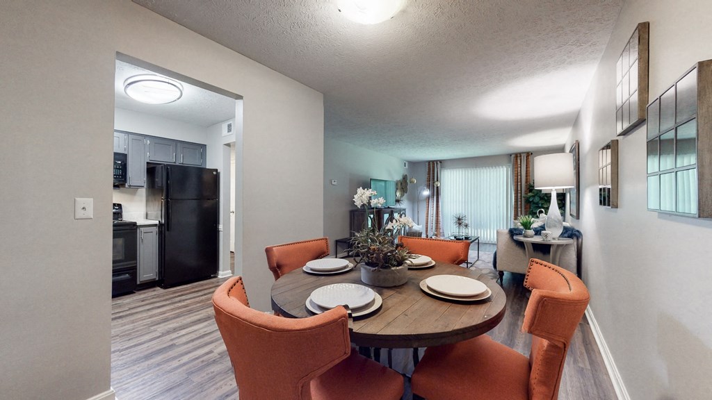 our apartments have a dining room and living room with a table and chairs