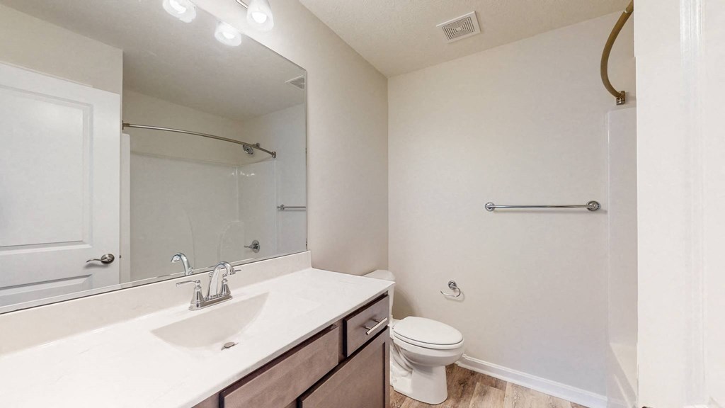 a bathroom with a sink toilet and a mirror
