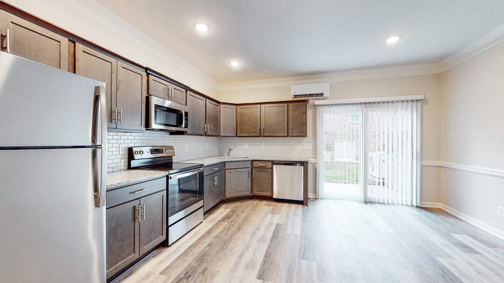 a kitchen with stainless steel appliances and wooden cabinets