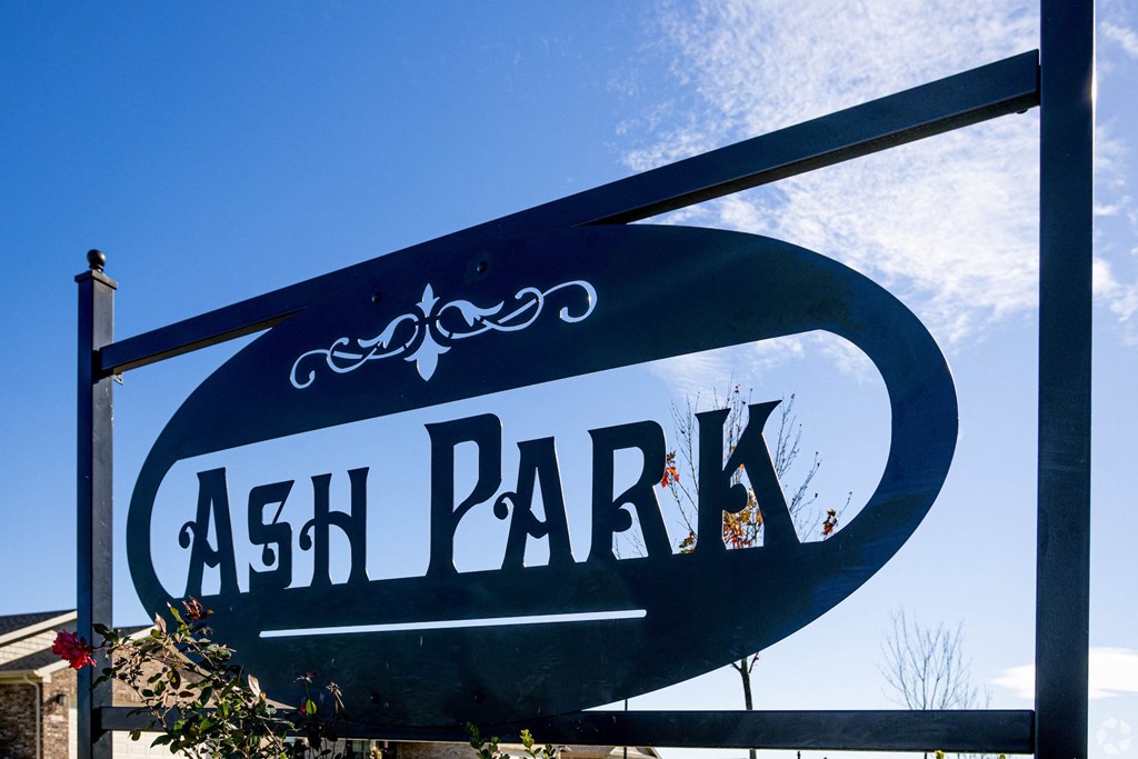 a sign that says ask park in front of a building