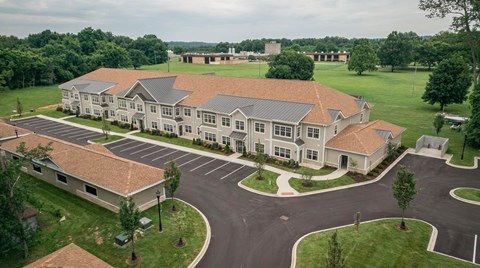 A large building with a parking lot in front of it.