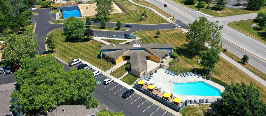 arial view of a building with a pool and parking lot