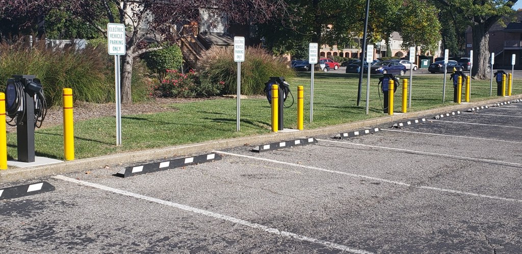 a parking lot with yellow and black dividers on the ground