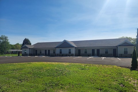 A large building with a parking lot in front of it.