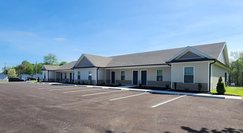 A building with a parking lot in front of it.