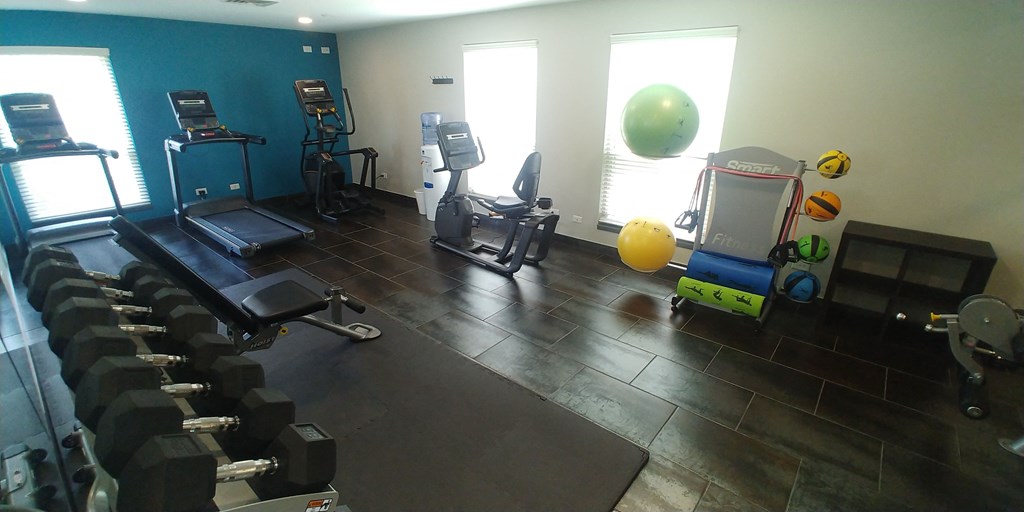 a room filled with lots of different types of exercise equipment