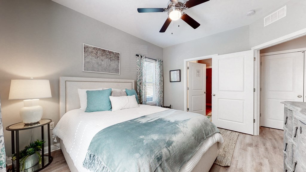 a bedroom with a bed and a ceiling fan