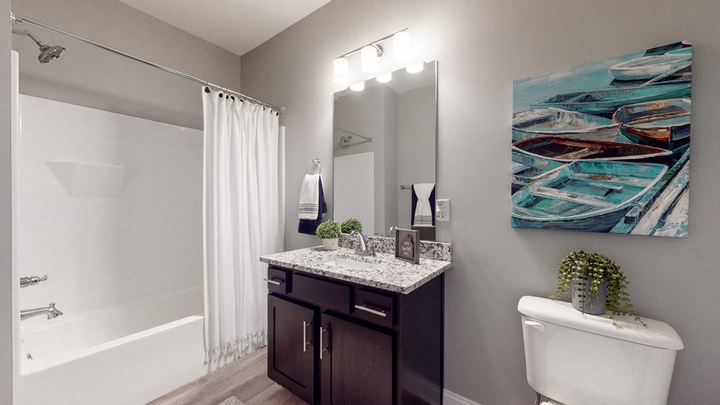 a bathroom with a shower toilet and sink