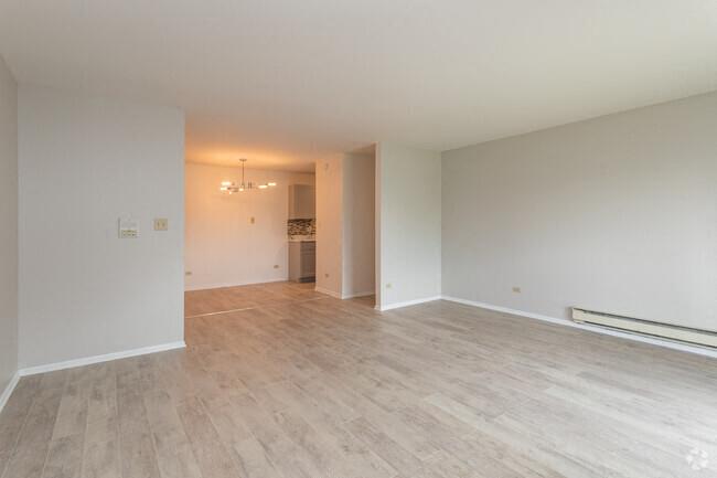 an empty living room with a hard wood floor