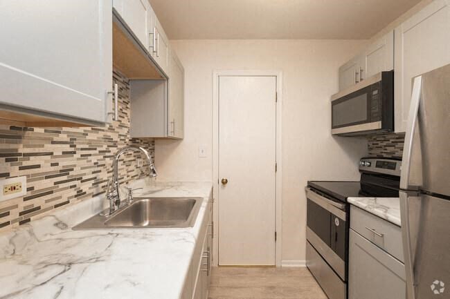 a kitchen with a sink and a refrigerator