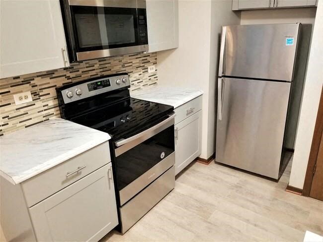 a kitchen with a stove and a refrigerator