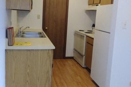 a small kitchen with a sink and a refrigerator