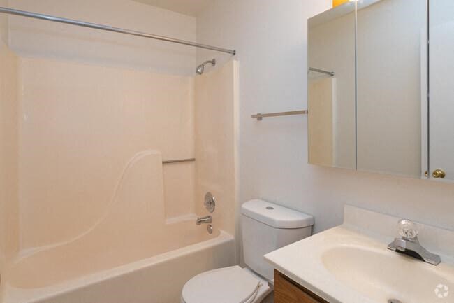 a white bathroom with a toilet and a sink