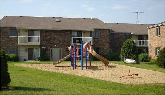 a playground in front of an apartment building