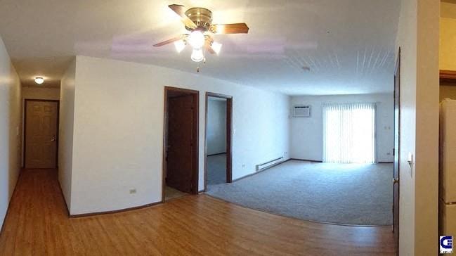 an empty living room with a ceiling fan