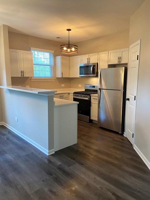 a kitchen with white cabinets and stainless steel appliances