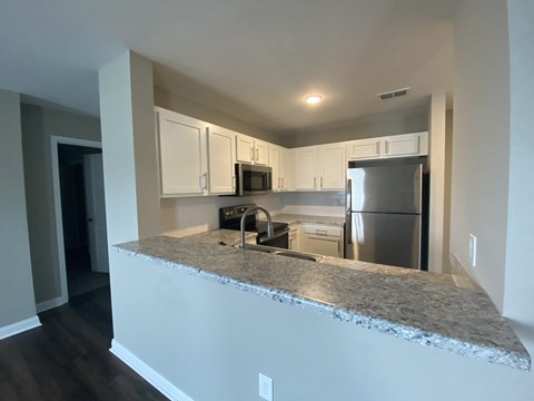 a kitchen with granite counter top and stainless steel appliances