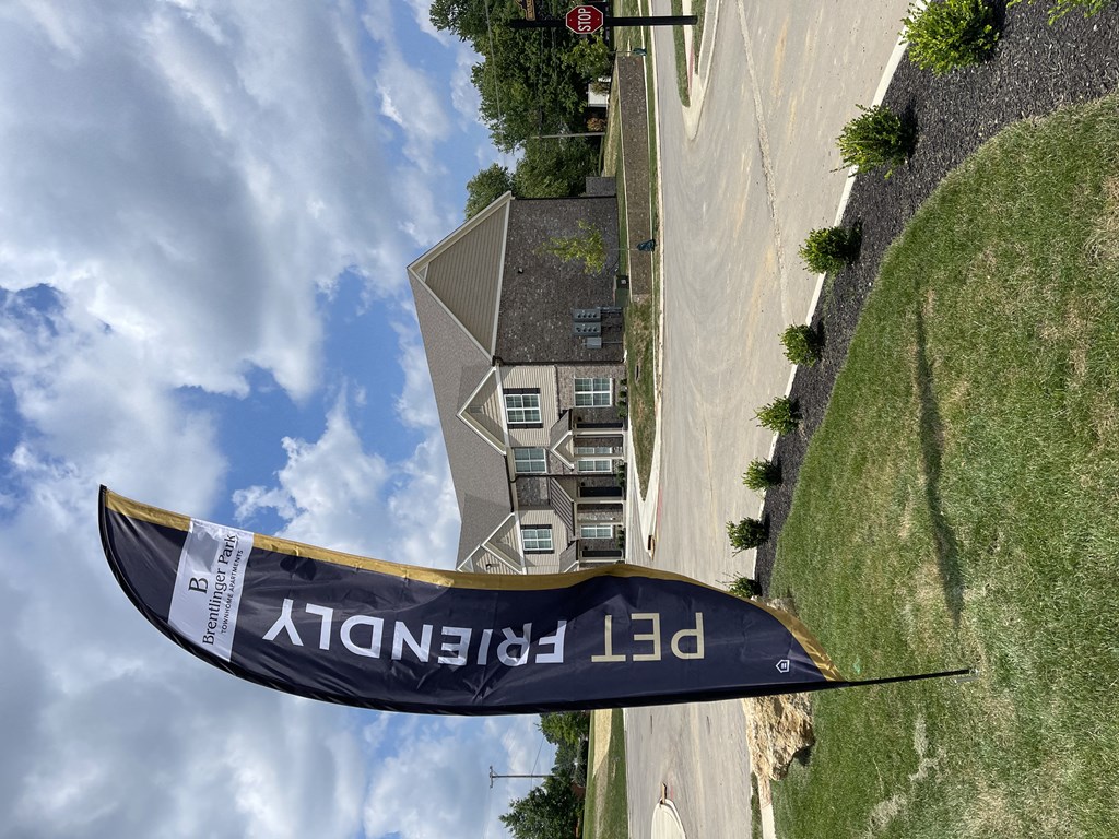 a view of a house with a kennedy ld banner in the grass