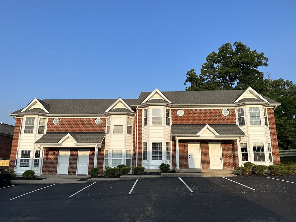 a house with two garages and a parking lot