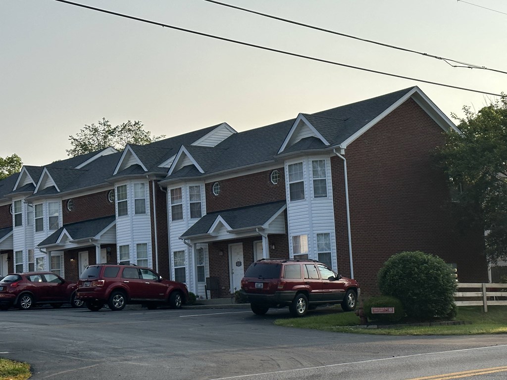 a house with three cars parked in front of it