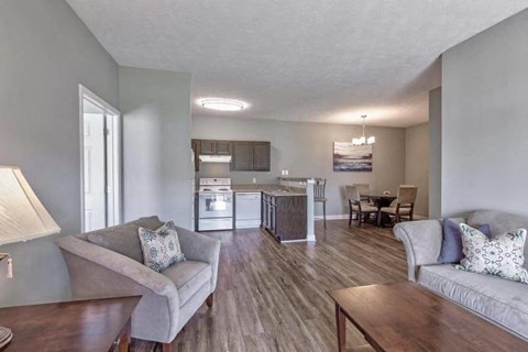 a living room and kitchen with a couch and a table