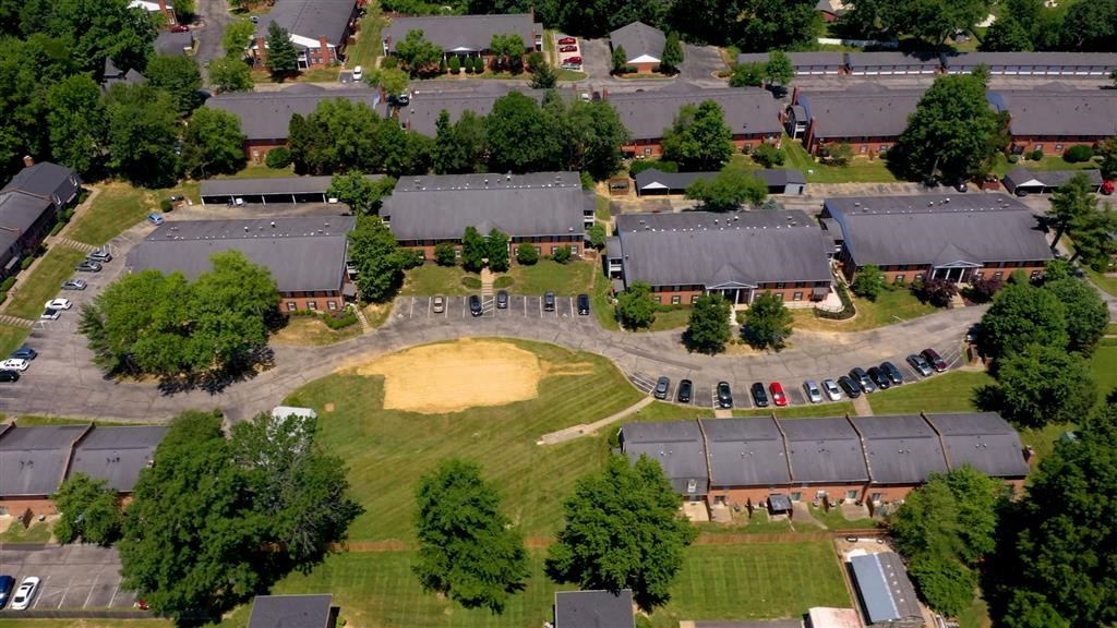 an aerial view of a neighborhood with houses and a baseball field